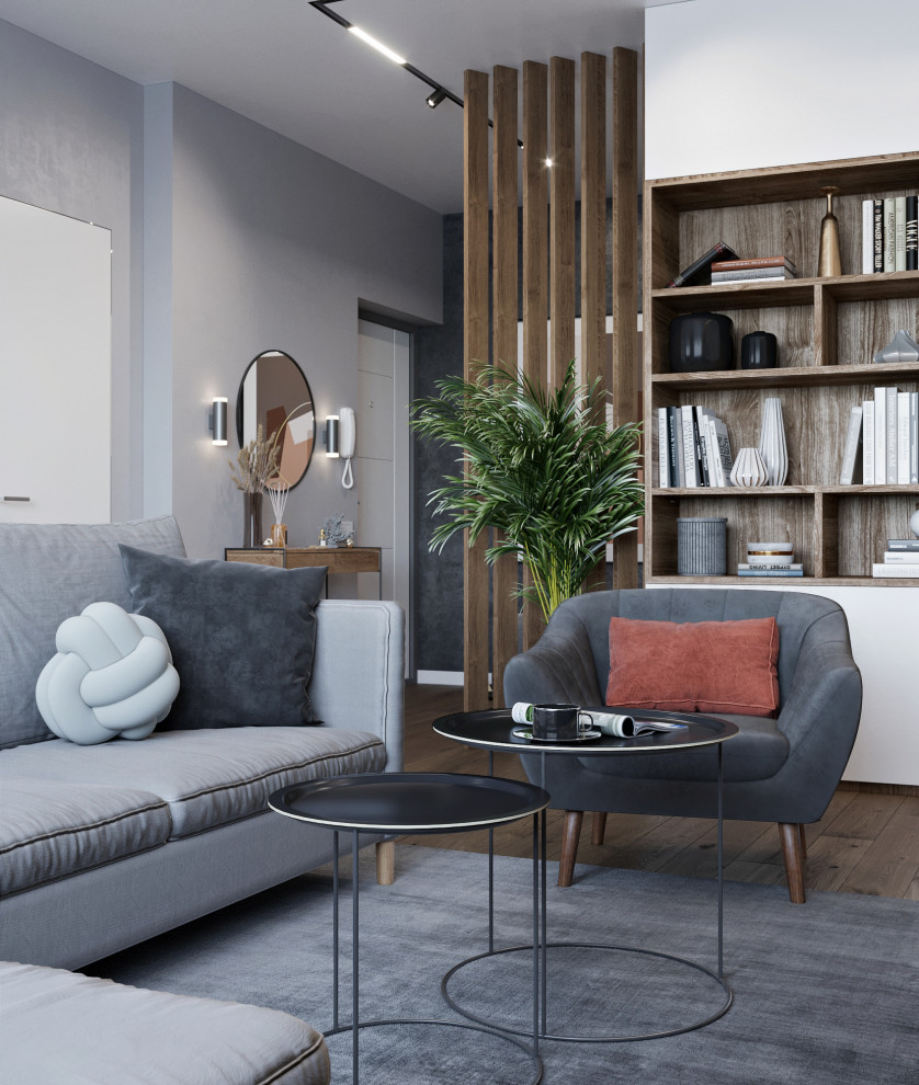 Idee per un soggiorno design di medie dimensioni e aperto con pareti grigie, pavimento in laminato, TV a parete e pavimento marrone