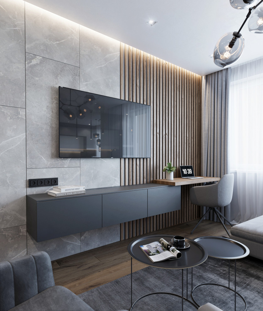 Aménagement d'un salon contemporain de taille moyenne et ouvert avec un mur gris, sol en stratifié, un téléviseur fixé au mur et un sol marron.
