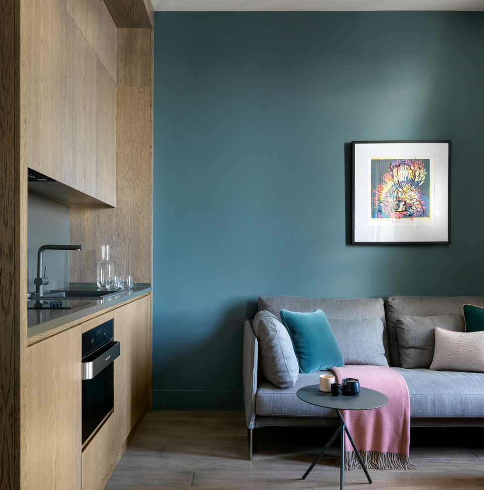 Стильный дизайн: маленькая объединенная гостиная комната в современном стиле с коричневыми стенами, паркетным полом среднего тона, телевизором на стене и коричневым полом для на участке и в саду - последний тренд