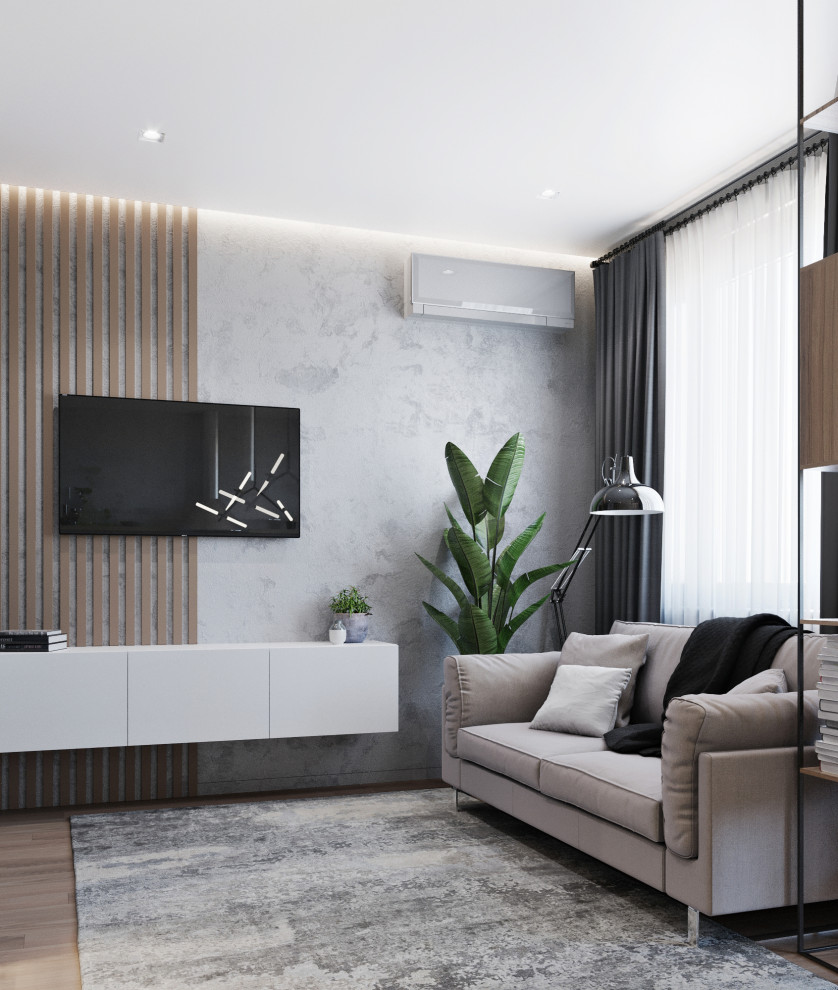 Immagine di un piccolo soggiorno contemporaneo aperto con pareti grigie, pavimento in laminato e TV a parete