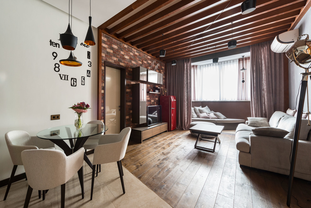Aménagement d'un salon industriel de taille moyenne et ouvert avec un mur multicolore, un sol en bois brun et un téléviseur indépendant.