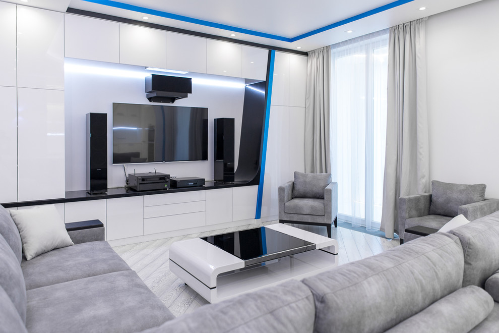 На фото: большая гостиная комната в современном стиле с белыми стенами, телевизором на стене, светлым паркетным полом, серым полом и музыкальной комнатой