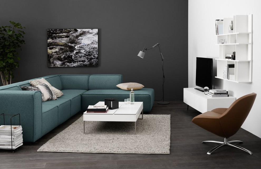 This is an example of a contemporary living room in Moscow with dark hardwood flooring and a freestanding tv.