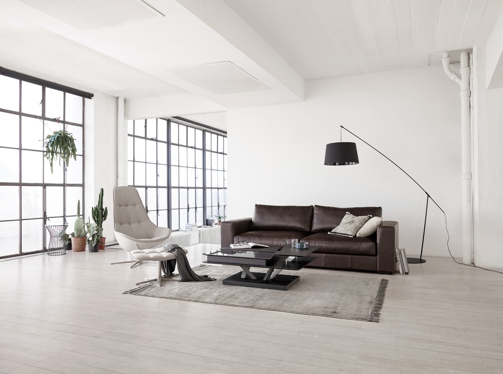 Photo of a contemporary living room in Moscow with light hardwood flooring.