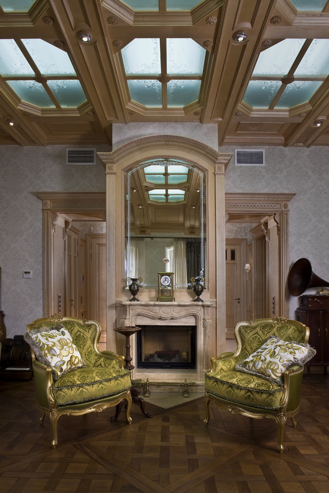 На фото: гостиная комната в викторианском стиле с паркетным полом среднего тона, стандартным камином и серыми стенами без телевизора