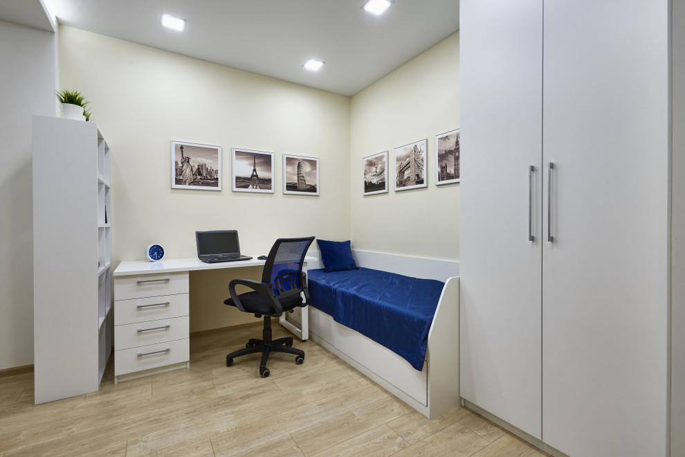 Foto di un soggiorno minimal di medie dimensioni con pareti beige, pavimento in laminato, TV a parete, pavimento beige e soffitto ribassato
