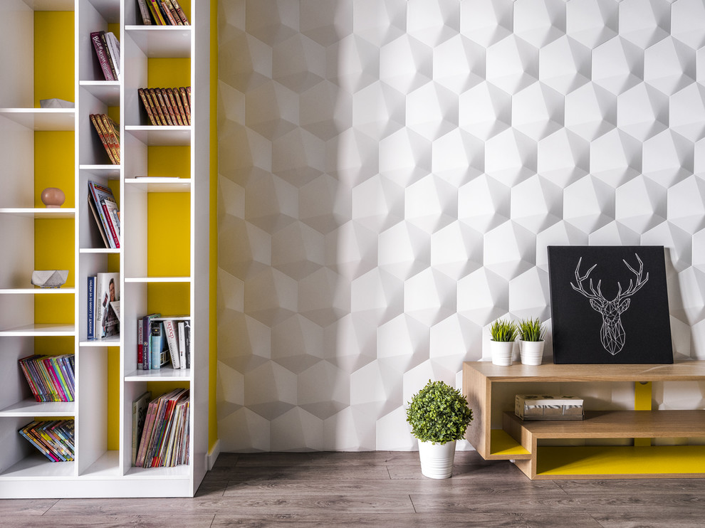 Immagine di un soggiorno design di medie dimensioni e chiuso con libreria, pareti bianche, pavimento in laminato e pavimento beige