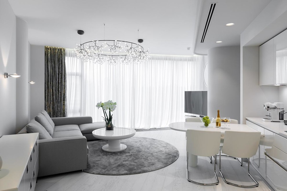 Inspiration pour un salon design ouvert avec une salle de réception, un mur blanc et parquet clair.