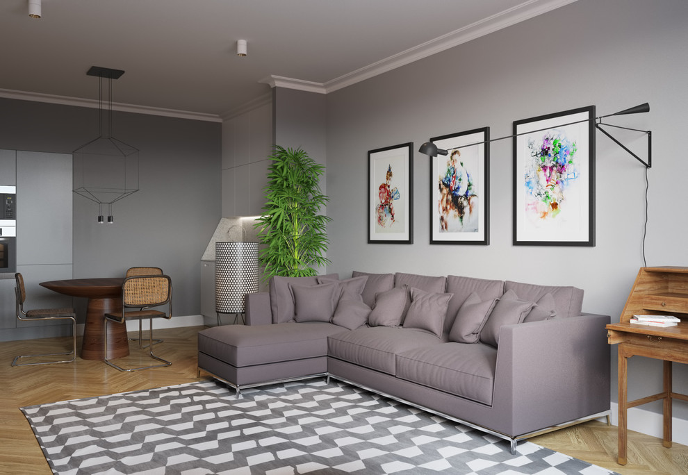 Стильный дизайн: открытая, объединенная гостиная комната в современном стиле с серыми стенами и светлым паркетным полом - последний тренд