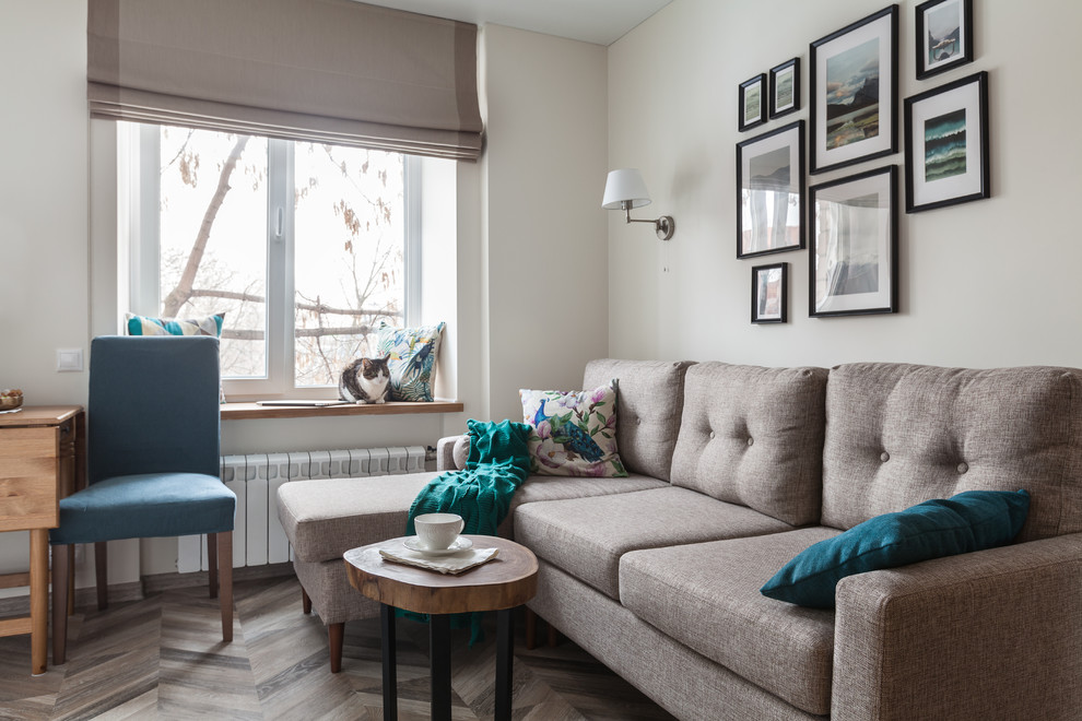 Photo of a small traditional formal open plan living room in Moscow with beige walls, laminate floors, a standard fireplace and brown floors.