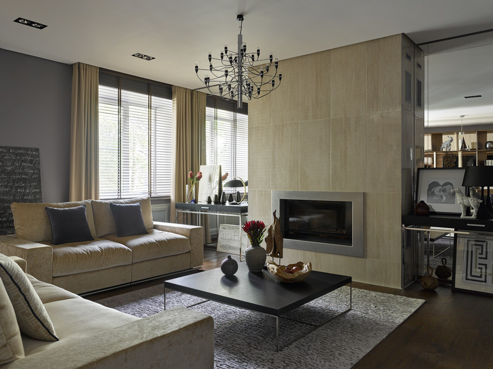 Идея дизайна: парадная гостиная комната в современном стиле с серыми стенами, темным паркетным полом и стандартным камином