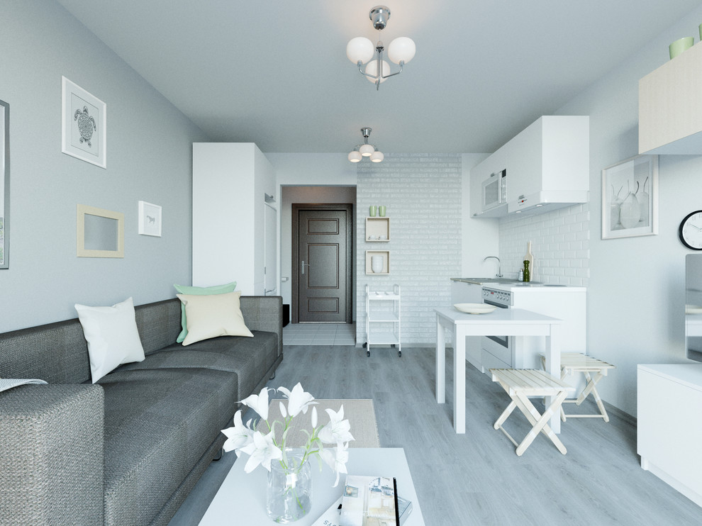 Свежая идея для дизайна: маленькая открытая, объединенная гостиная комната в скандинавском стиле с серыми стенами, полом из ламината, отдельно стоящим телевизором и серым полом для на участке и в саду - отличное фото интерьера