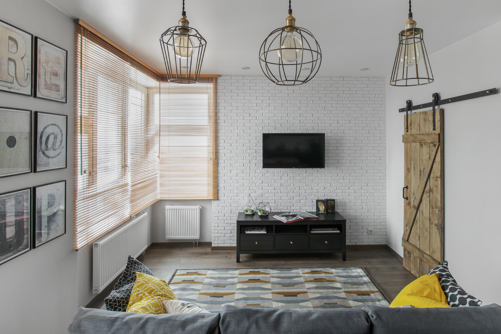 Пример оригинального дизайна: открытая гостиная комната в стиле лофт с серыми стенами