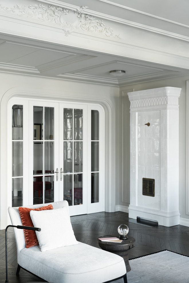 Aménagement d'un salon classique avec un mur blanc et parquet foncé.