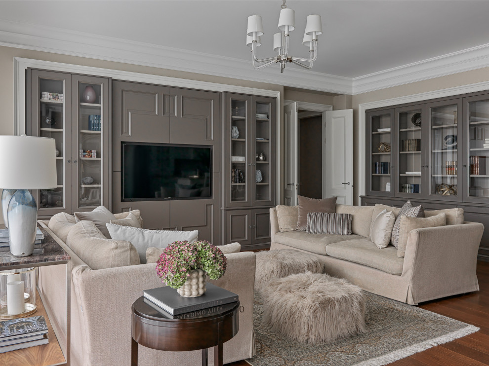 Esempio di un soggiorno chic con pareti beige, pavimento in legno massello medio, TV a parete e pavimento marrone
