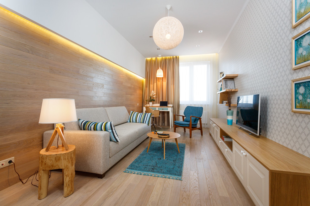 Ejemplo de sala de estar nórdica sin chimenea con paredes blancas, suelo de madera en tonos medios y televisor independiente