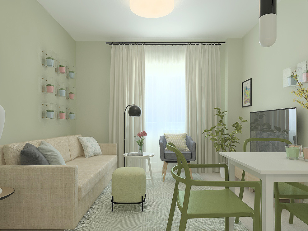 На фото: маленькая открытая гостиная комната в современном стиле с зелеными стенами, полом из ламината, отдельно стоящим телевизором и серым полом для на участке и в саду с