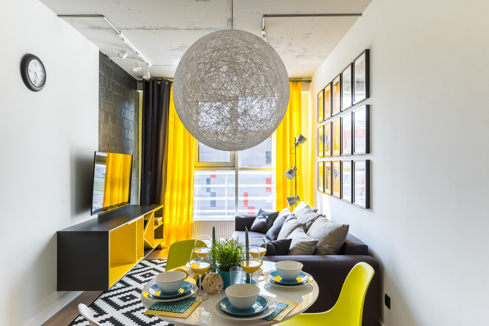 Inspiration for an industrial open concept medium tone wood floor and brown floor living room remodel in Saint Petersburg with white walls and a wall-mounted tv