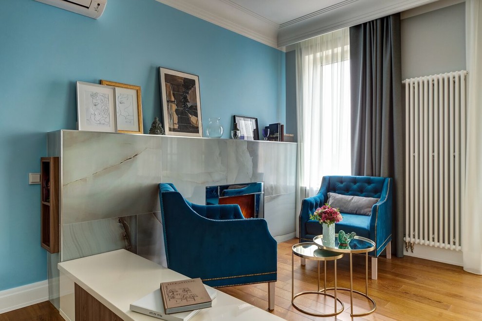 Réalisation d'un salon tradition de taille moyenne avec un mur bleu et un sol marron.