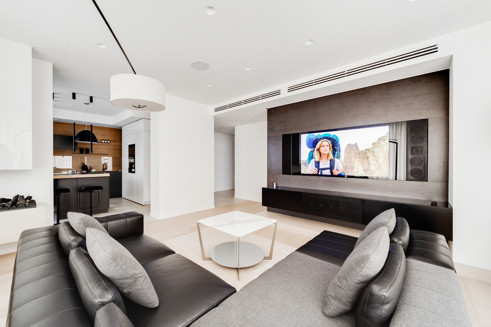 Inspiration for a contemporary open plan living room in Moscow with white walls, light hardwood flooring, beige floors, a wall mounted tv and feature lighting.