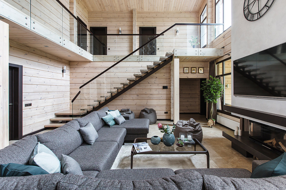 Immagine di un soggiorno design con sala formale, pareti beige, camino classico, TV a parete e pavimento beige
