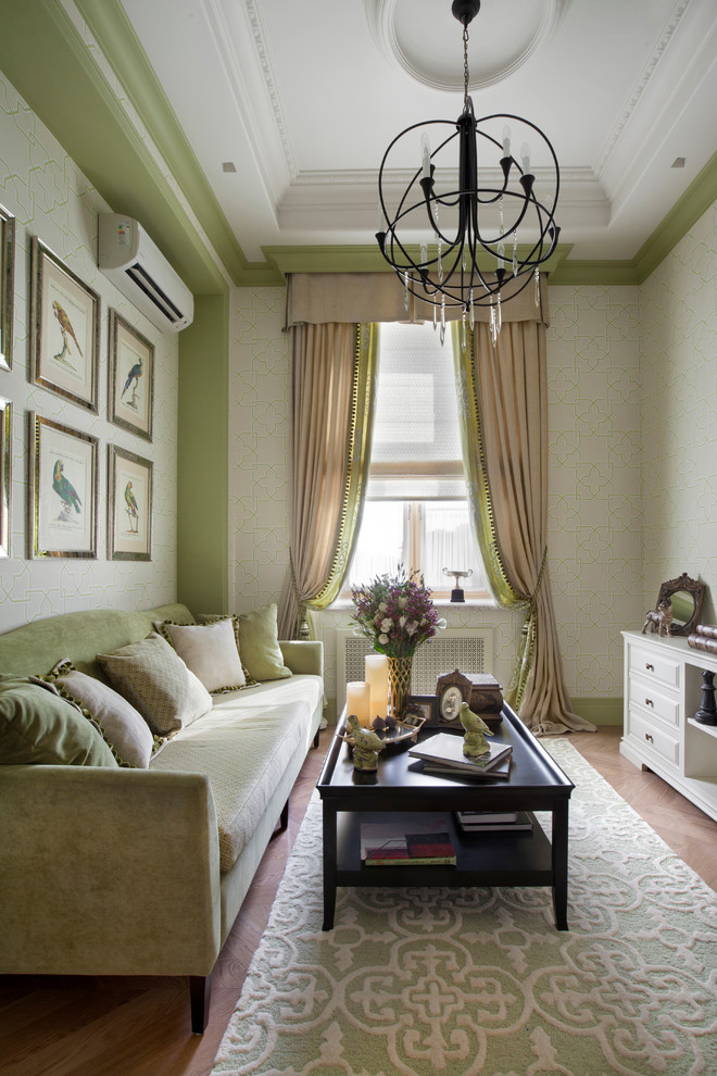 Example of a classic formal and enclosed living room design in Moscow with green walls and no fireplace
