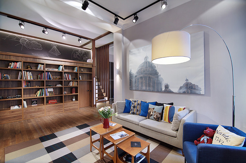 Medium sized industrial mezzanine living room in Saint Petersburg with a reading nook, grey walls, medium hardwood flooring and no tv.