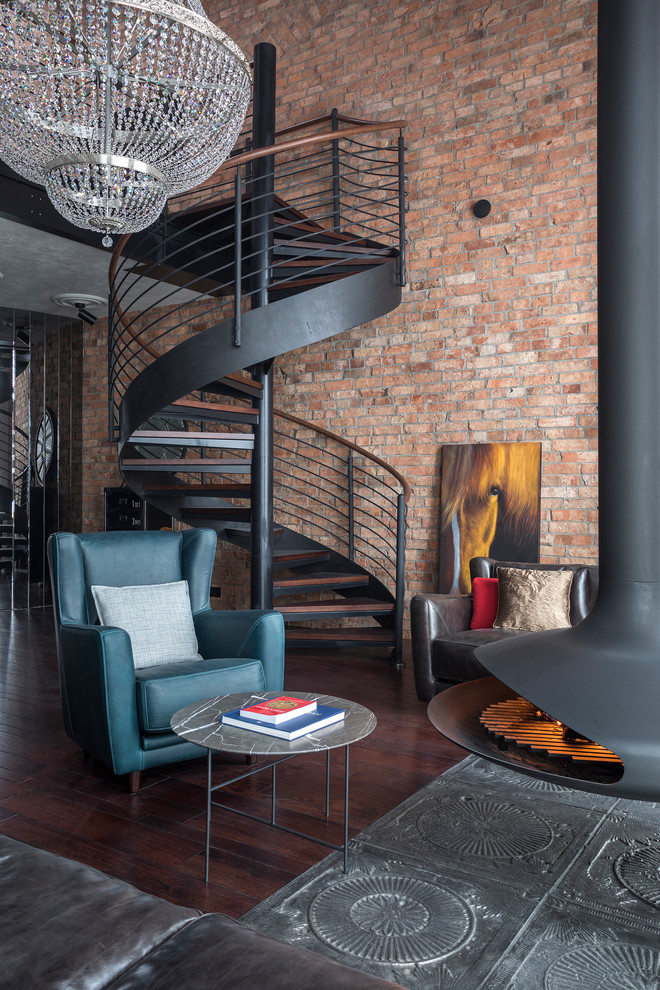 Example of an urban open concept dark wood floor and brown floor living room design in Moscow with a hanging fireplace, a metal fireplace and brown walls