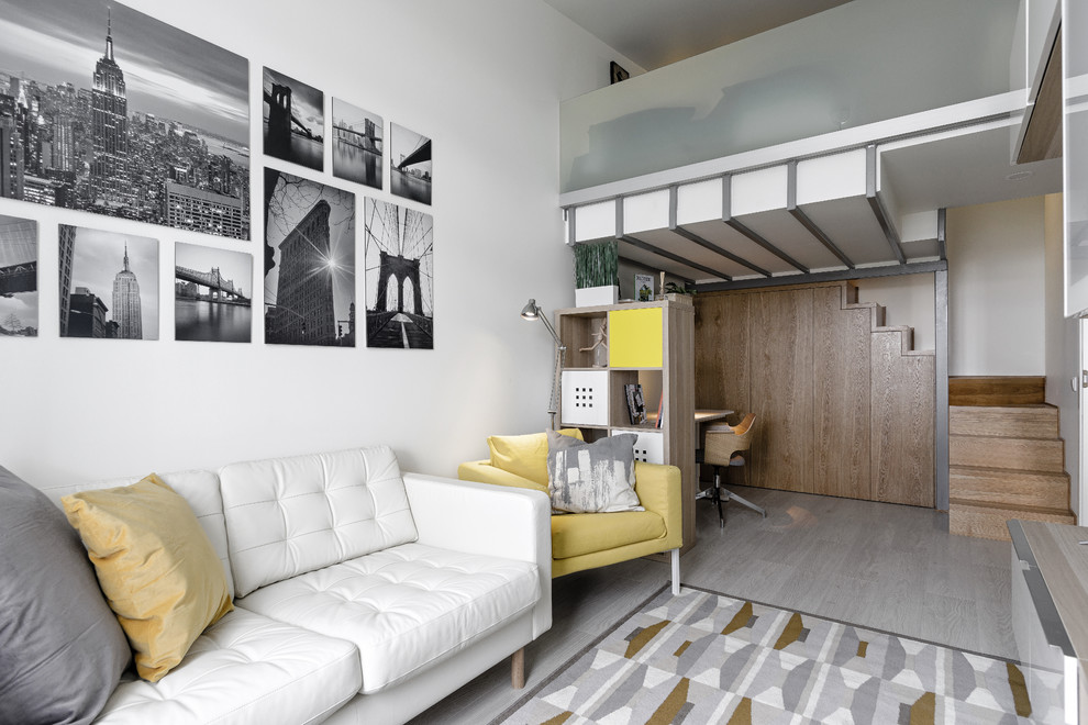 Immagine di un soggiorno nordico stile loft con pareti bianche e pavimento in laminato