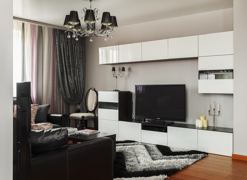 Идея дизайна: парадная, открытая гостиная комната среднего размера в современном стиле с серыми стенами, паркетным полом среднего тона и отдельно стоящим телевизором без камина