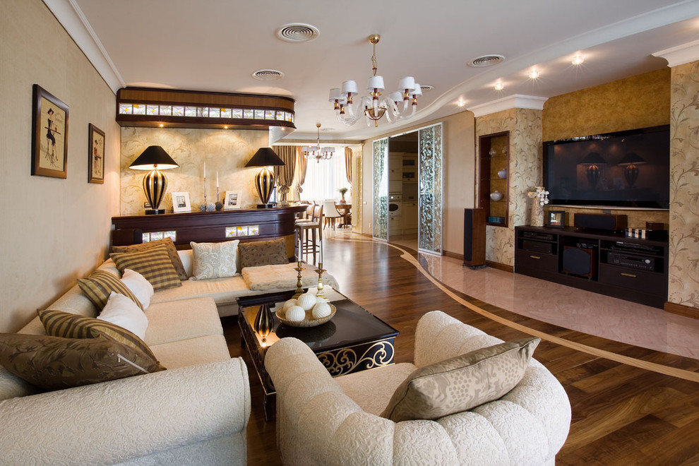 This is an example of an expansive traditional open plan living room in Moscow with a home bar, beige walls, medium hardwood flooring, brown floors and a wall mounted tv.