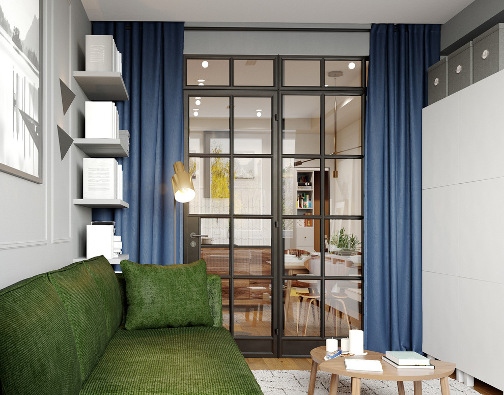 Идея дизайна: изолированная гостиная комната среднего размера в современном стиле с серыми стенами, паркетным полом среднего тона, телевизором на стене и коричневым полом без камина