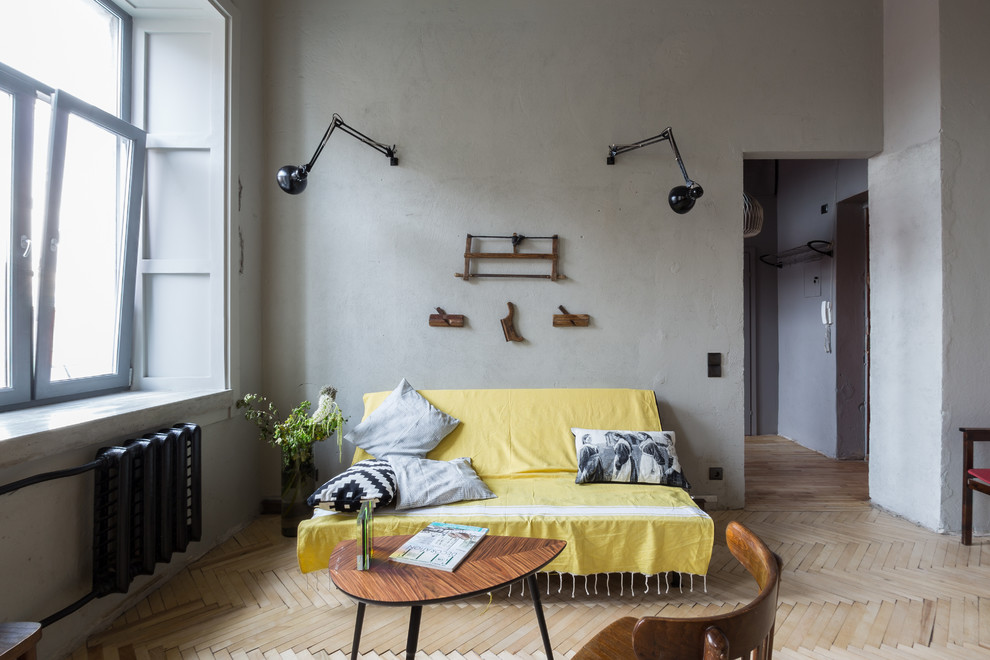 Inspiration for a small industrial mezzanine living room in Saint Petersburg with yellow walls and medium hardwood flooring.