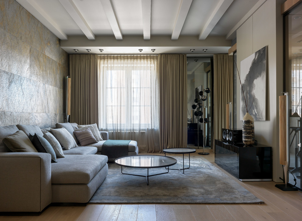 Bild på ett stort minimalistiskt allrum med öppen planlösning, med ett finrum, grå väggar, ljust trägolv och beiget golv