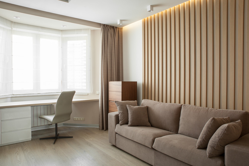 Design ideas for a medium sized contemporary living room in Moscow with a reading nook, white walls, light hardwood flooring, a wall mounted tv and beige floors.