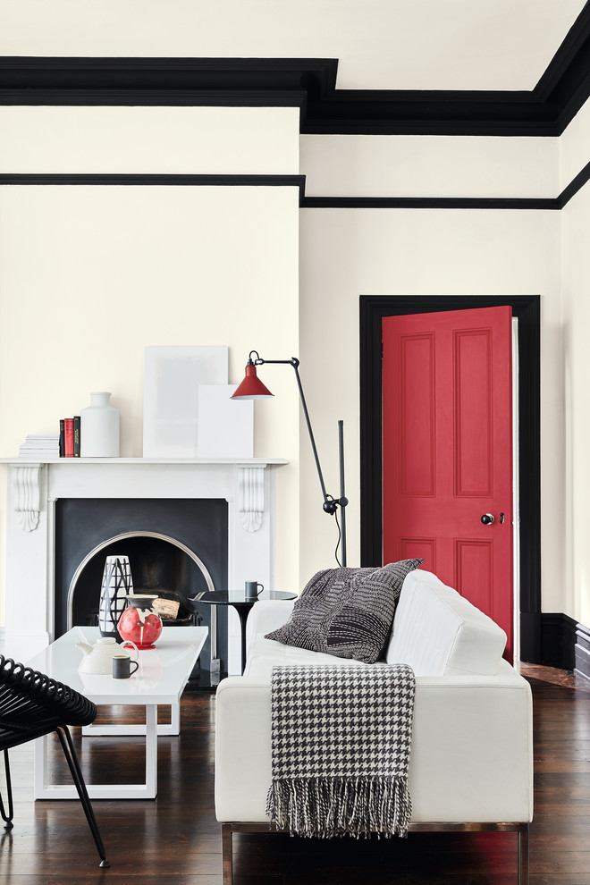 Photo of a traditional living room in Moscow with white walls, dark hardwood flooring, a standard fireplace and brown floors.