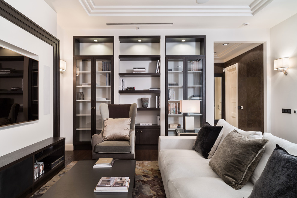 Immagine di un soggiorno design di medie dimensioni e aperto con parquet scuro, parete attrezzata, pareti bianche e pavimento marrone