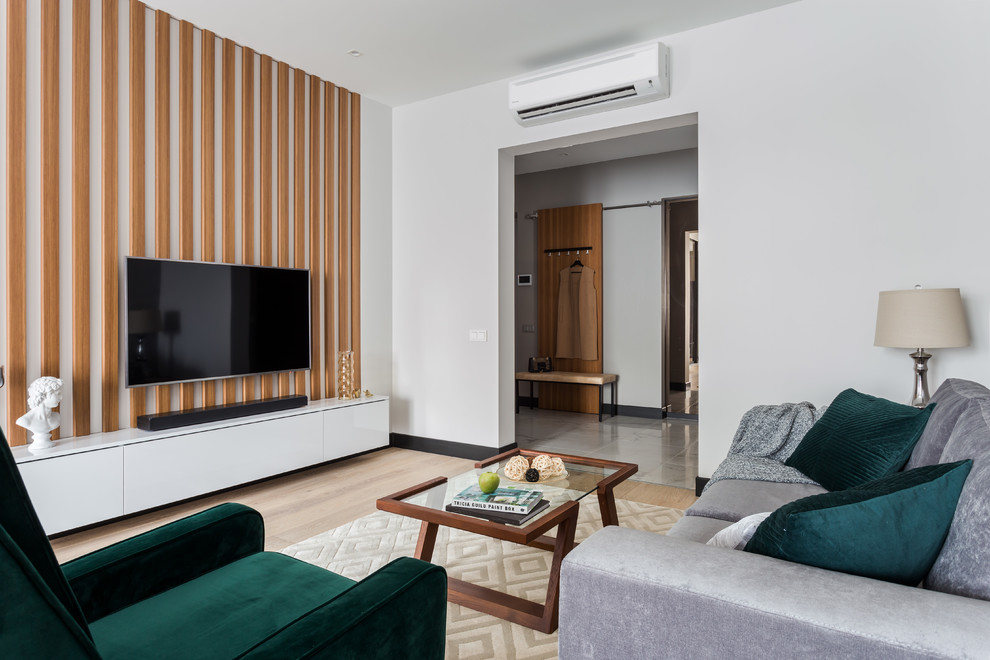 Foto di un grande soggiorno design aperto con pareti grigie, parquet chiaro, TV a parete e pavimento beige