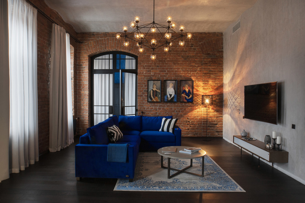 Esempio di un soggiorno industriale aperto con pareti multicolore, parquet scuro e TV a parete