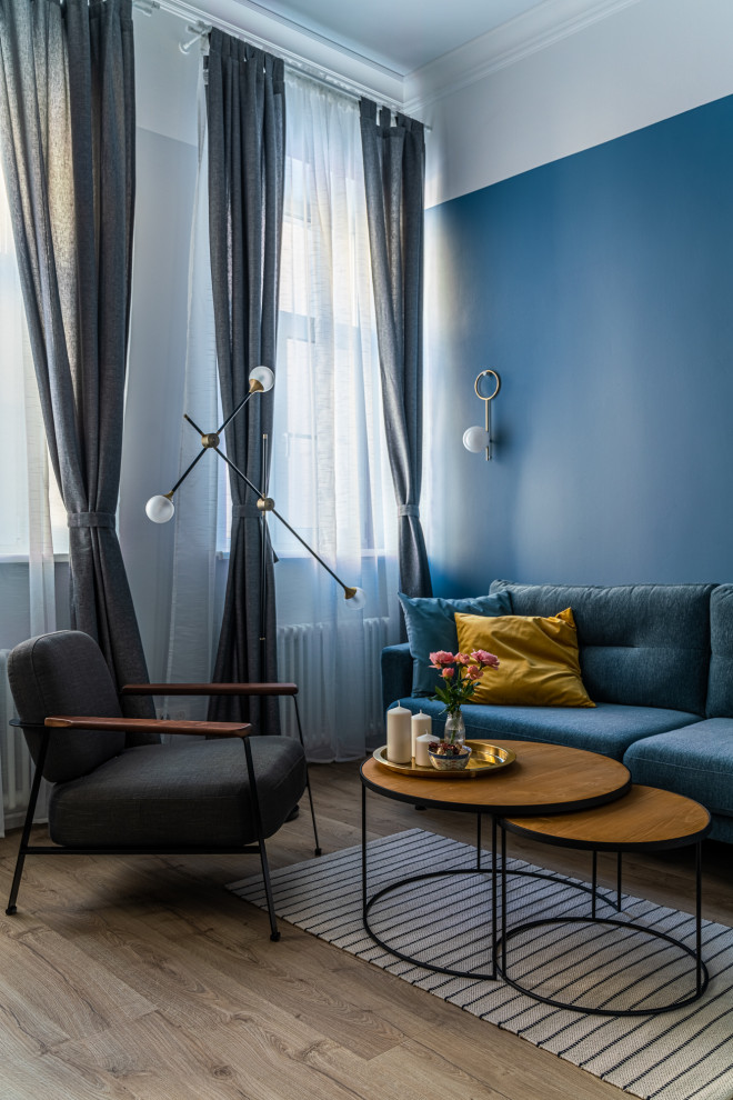 Medium sized scandinavian enclosed living room in Saint Petersburg with blue walls, medium hardwood flooring, no fireplace, no tv, brown floors and wallpapered walls.