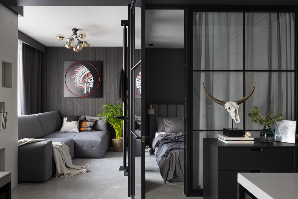 Идея дизайна: маленькая объединенная гостиная комната в стиле лофт с черными стенами, серым полом и бетонным полом без камина для на участке и в саду