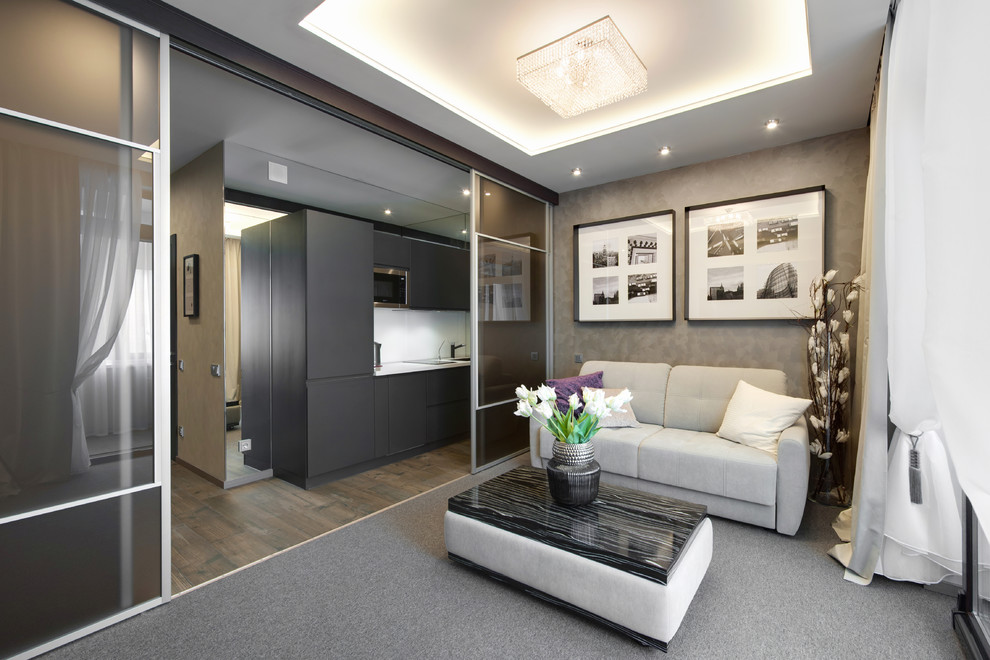 Imagen de salón abierto actual pequeño sin chimenea con paredes beige, moqueta y suelo gris
