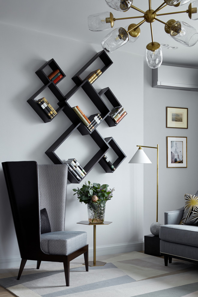 Idée de décoration pour un salon design avec un mur gris.