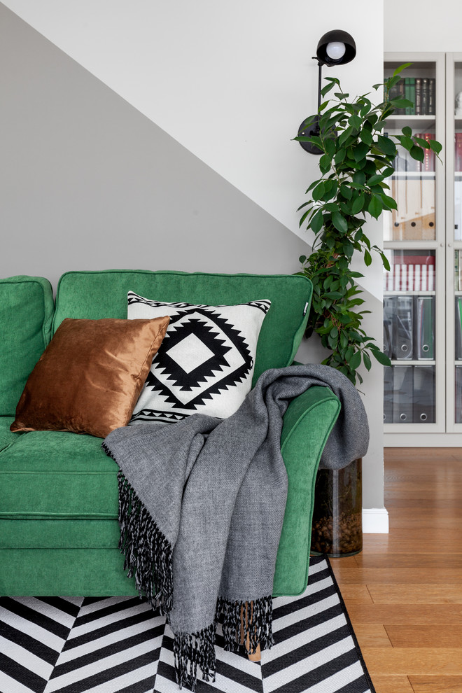 Diseño de salón nórdico sin televisor con paredes grises y suelo de madera en tonos medios