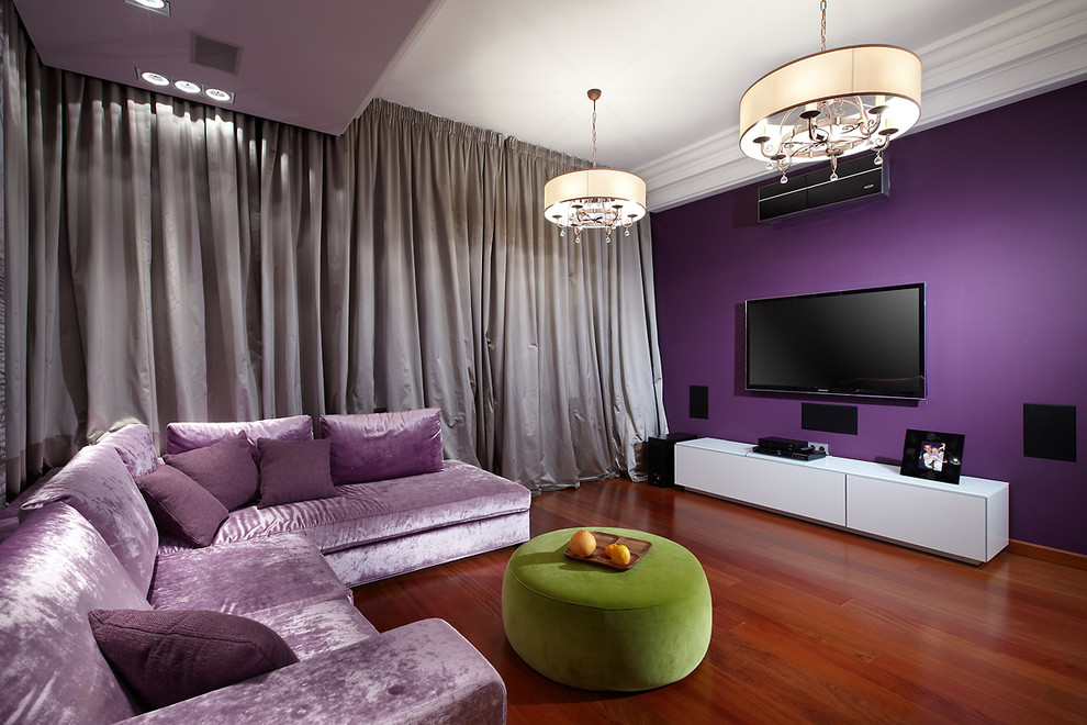 Cette image montre une salle de séjour design avec un mur violet, aucune cheminée et un téléviseur fixé au mur.