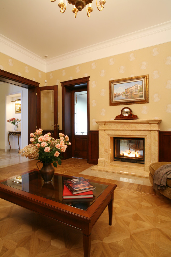 Example of a living room design in Moscow with a standard fireplace