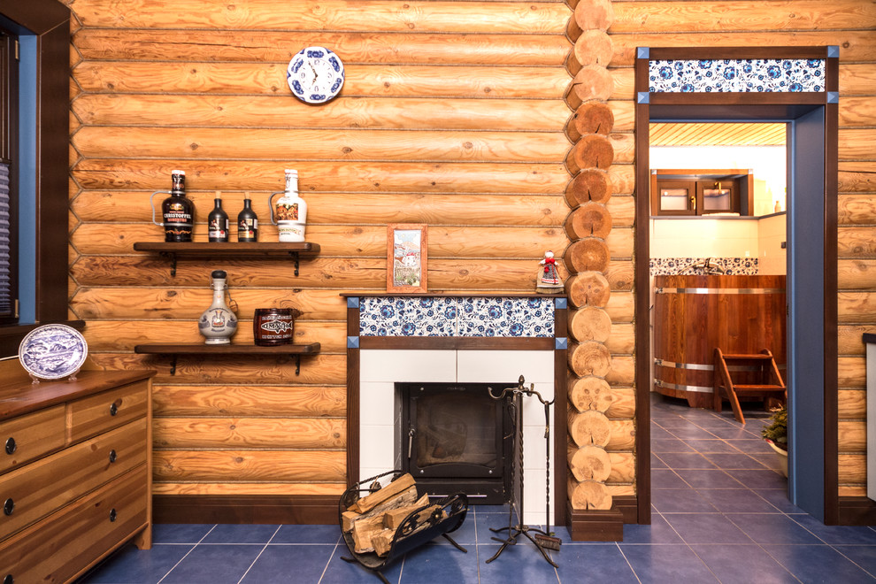 Photo of a small farmhouse enclosed living room in Moscow with brown walls, ceramic flooring, a standard fireplace, a tiled fireplace surround, a wall mounted tv and blue floors.