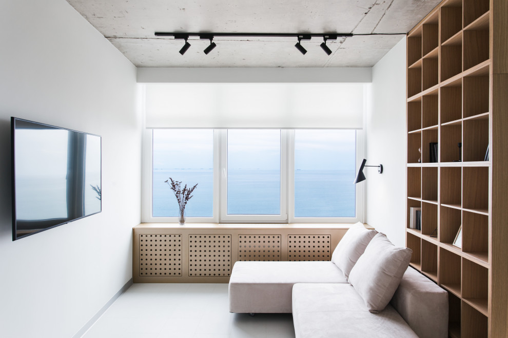 Example of a mid-sized trendy porcelain tile and gray floor living room design in Other with white walls and a wall-mounted tv