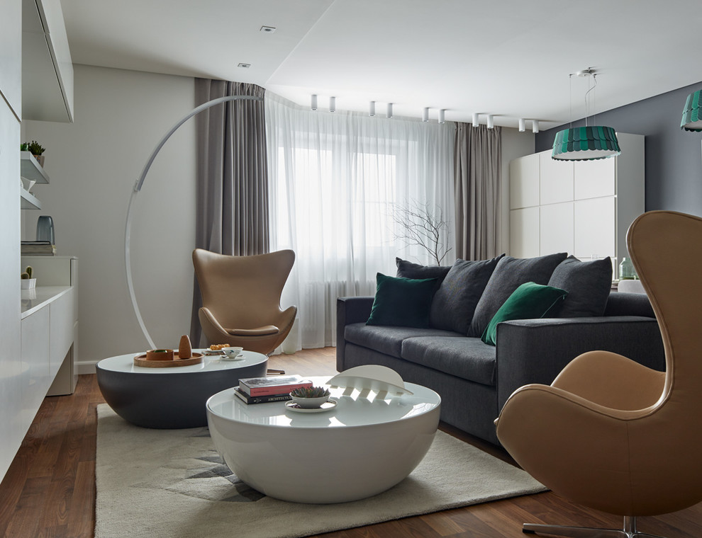 Danish formal and open concept medium tone wood floor living room photo in Moscow with white walls