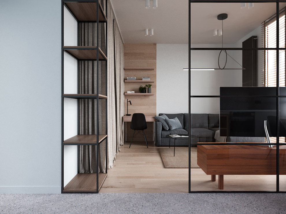 Стильный дизайн: маленькая изолированная гостиная комната в скандинавском стиле с серыми стенами, отдельно стоящим телевизором, с книжными шкафами и полками, полом из ламината и бежевым полом для на участке и в саду - последний тренд